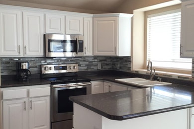 Inspiration for a mid-sized modern ceramic tile and brown floor kitchen remodel in Austin with a drop-in sink, raised-panel cabinets, white cabinets, granite countertops, multicolored backsplash, matchstick tile backsplash and a peninsula