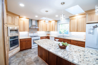 Kitchen - large transitional u-shaped vinyl floor and multicolored floor kitchen idea in Other with an undermount sink, shaker cabinets, brown cabinets, quartz countertops, white appliances, an island and multicolored countertops