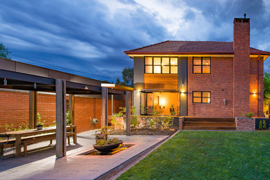 Inspiration for a large midcentury two-storey brick exterior in Canberra - Queanbeyan.