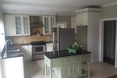 Inspiration for a mid-sized country u-shaped eat-in kitchen remodel in New York with glass-front cabinets and white cabinets