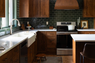 Mid-sized transitional l-shaped medium tone wood floor and brown floor kitchen pantry photo in Other with a farmhouse sink, shaker cabinets, medium tone wood cabinets, quartz countertops, green backsplash, subway tile backsplash, stainless steel appliances, an island and white countertops