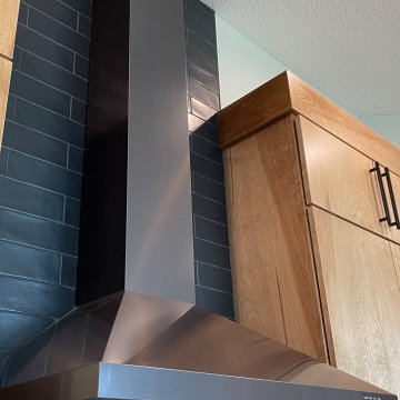 Angled Kitchen Design with Slab Style Cabinets in Pecan Stain