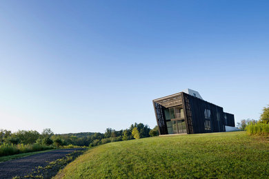 Example of a mid-sized minimalist two-story mixed siding exterior home design in Denver with a green roof