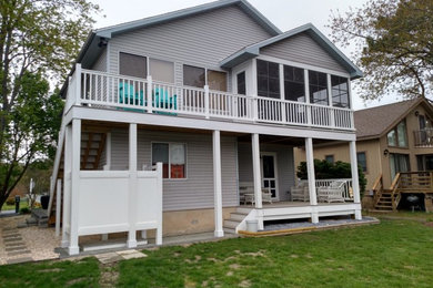 Large traditional gray two-story wood exterior home idea in Other with a shingle roof