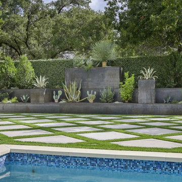 Poolside Landscape Design Featuring Custom Planters and Structured Planting Area