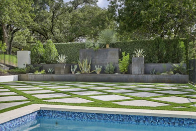 Design ideas for a large modern privacy and full sun backyard concrete paver and metal fence formal garden in Other for summer.