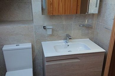 This is an example of a small contemporary ensuite bathroom in Other with a walk-in shower, a wall-mounted sink and an open shower.