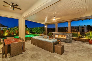 Large arts and crafts backyard stone patio photo in San Francisco with a fire pit and a pergola