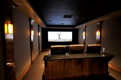 Inspiration for a mid-sized enclosed home theatre in Baltimore with beige walls, carpet, a projector screen and brown floor.
