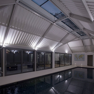 Design ideas for a medium sized contemporary multi-use home gym in London with white walls, ceramic flooring and white floors.