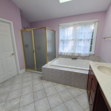 Original Primary Bath with Corner Tub and Pink Walls (Before)