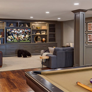 Traditional basement in Chicago with grey walls, dark hardwood flooring and brown floors.