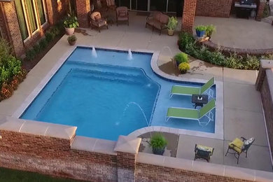 Pool fountain - transitional courtyard stamped concrete and custom-shaped pool fountain idea in Oklahoma City