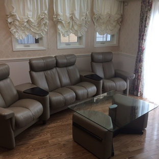 This is an example of a modern open plan home cinema in Other with beige walls, plywood flooring and brown floors.