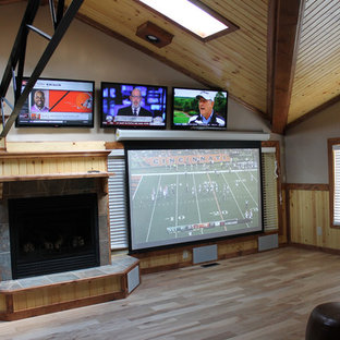 Example of a huge arts and crafts enclosed light wood floor home theater design in Cleveland with white walls and a projector screen