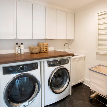 Laundry Room Renovation with Storage Cabinets and Wood Countertop