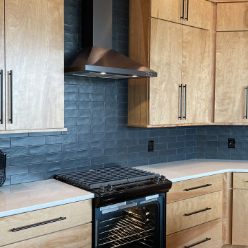 Angled Kitchen Design with Slab Style Cabinets in Pecan Stain