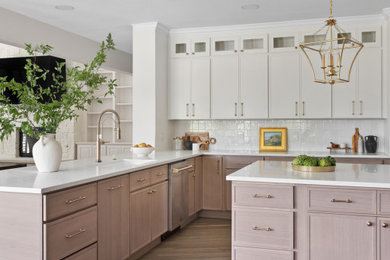 Example of a large transitional light wood floor kitchen design in Dallas with a single-bowl sink, light wood cabinets, quartz countertops, white backsplash, ceramic backsplash, an island and white countertops