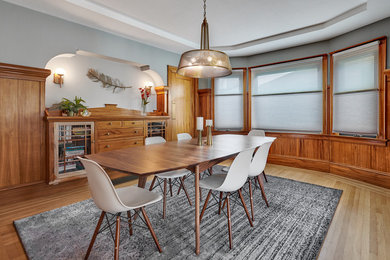 Mid-sized 1950s medium tone wood floor and brown floor enclosed dining room photo in San Francisco with gray walls and a standard fireplace
