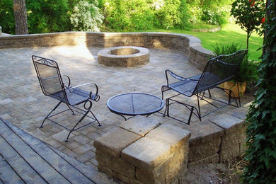 Example of a mid-sized arts and crafts backyard concrete paver patio design in Other with a fire pit and no cover