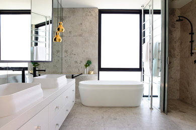 Design ideas for a contemporary bathroom in Melbourne with a freestanding tub and a vessel sink.