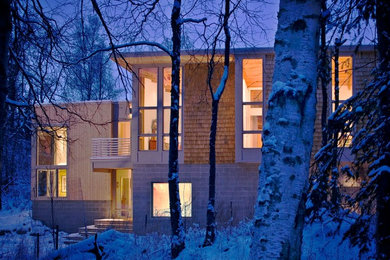 Contemporary two-story mixed siding exterior home idea in Other