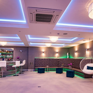 Design ideas for a medium sized contemporary fully buried basement in Buckinghamshire with white walls and grey floors.