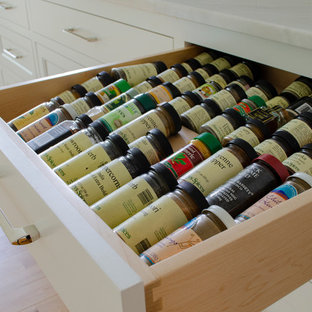 Photo of a large scandinavian u-shaped kitchen pantry in Cleveland with an undermount sink, white cabinets, quartzite benchtops, white splashback, ceramic splashback, stainless steel appliances, light hardwood floors, with island and white benchtop.