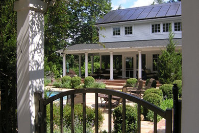 This is an example of a large traditional backyard stone landscaping in Philadelphia with a fire pit for spring.
