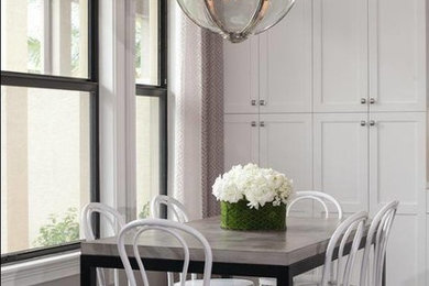 Example of a mid-sized trendy vinyl floor and gray floor kitchen/dining room combo design in Miami with gray walls and no fireplace
