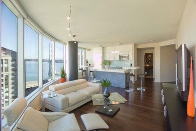 Family room - mid-sized modern open concept dark wood floor family room idea in San Francisco with a bar, beige walls, no fireplace and a wall-mounted tv