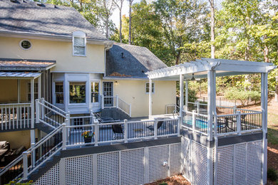 Example of a mid-sized classic backyard deck design in Atlanta with a pergola