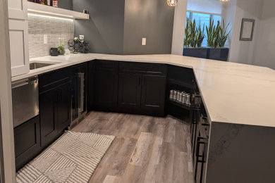 Example of a transitional home bar design in Denver