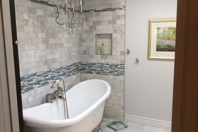 Inspiration for a mid-sized transitional master marble floor claw-foot bathtub remodel in Other with gray walls