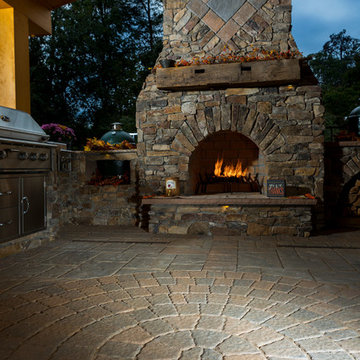 Outdoor fireplace with grill island and big green egg