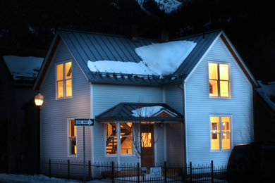 Small traditional blue three-story wood gable roof idea in Denver