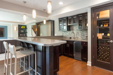 Small transitional l-shaped medium tone wood floor open concept kitchen photo in Orange County with an undermount sink, shaker cabinets, dark wood cabinets, stainless steel countertops, multicolored backsplash, mosaic tile backsplash, stainless steel appliances and a peninsula