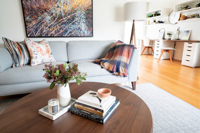 Mid-sized transitional enclosed living room photo in Vancouver with white walls, a standard fireplace and a brick fireplace