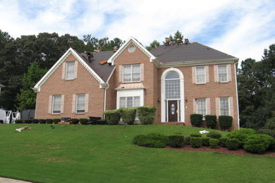 Inspiration for a large timeless beige two-story brick exterior home remodel in Chicago with a shingle roof