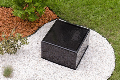 Small modern stone exterior home idea in Other