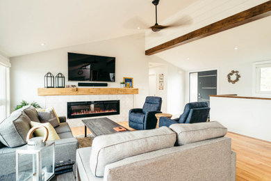 Inspiration for a mid-sized modern formal and open concept medium tone wood floor and brown floor living room remodel in Other with white walls, a standard fireplace, a tile fireplace and a wall-mounted tv