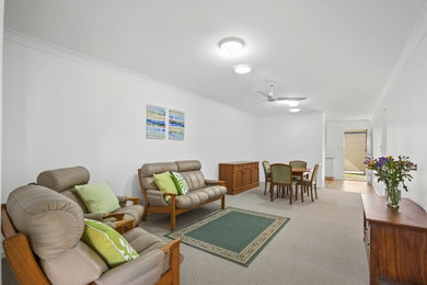 Photo of a mid-sized traditional open concept living room in Gold Coast - Tweed with carpet.