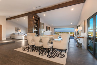Photo of a mid-sized contemporary kitchen/dining combo in Orange County with white walls, ceramic floors, a standard fireplace, a stone fireplace surround and brown floor.