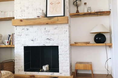 Inspiration for a living room remodel in Montreal with a brick fireplace