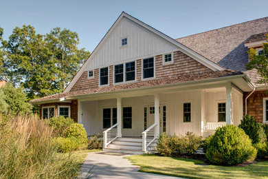 Inspiration for a large transitional white three-story wood exterior home remodel in Other with a shed roof