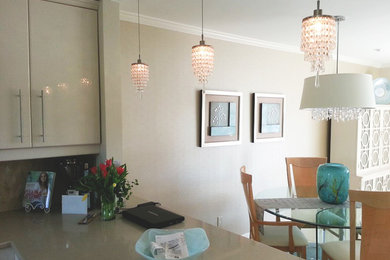 Inspiration for a mid-sized contemporary u-shaped open concept kitchen remodel in Miami with flat-panel cabinets, quartz countertops, an undermount sink, white cabinets, white appliances and a peninsula