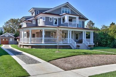 This is an example of a large beach style three-storey grey exterior in New York with vinyl siding.