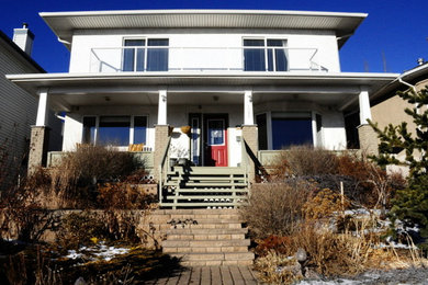 Mid-sized transitional white two-story stucco exterior home idea in Calgary