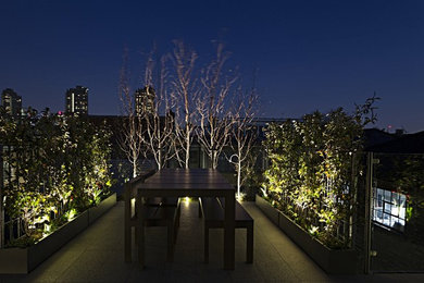 This is an example of a medium sized contemporary roof terrace in London with a living wall.