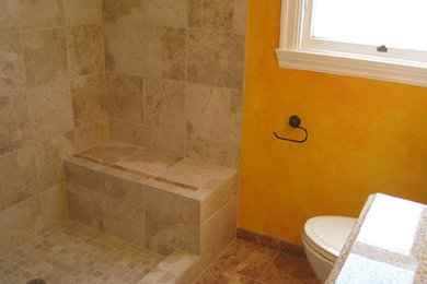 Example of a mid-sized classic beige tile ceramic tile corner shower design in San Francisco with a one-piece toilet and yellow walls